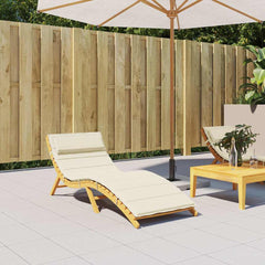 Cream Oxford fabric sun lounger cushion with non-slip straps on a wooden frame chair.