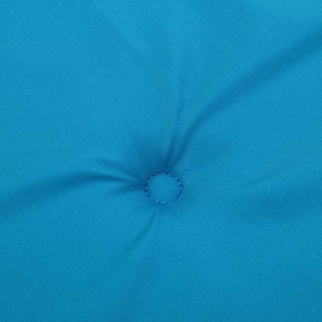 Close-up of light blue Oxford fabric with tufted button detail on chair cushion.