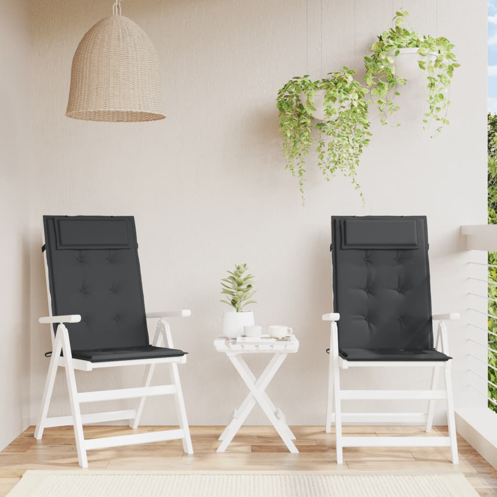 Two black Oxford fabric highback chair cushions on white patio chairs with ties and a small table.