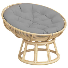 Gray round outdoor cushion with tufted Oxford fabric and natural rattan base.