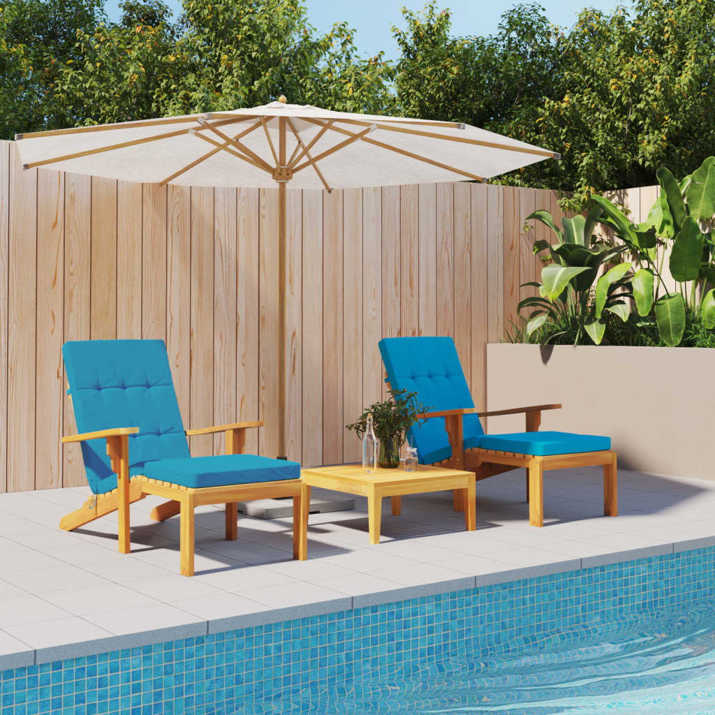 Two light blue Oxford fabric cushions on wooden deck chairs with a small table by the pool.