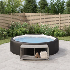 Two gray poly rattan storage shelves with shelves and towel, placed beside an inflatable hot tub on a patio.