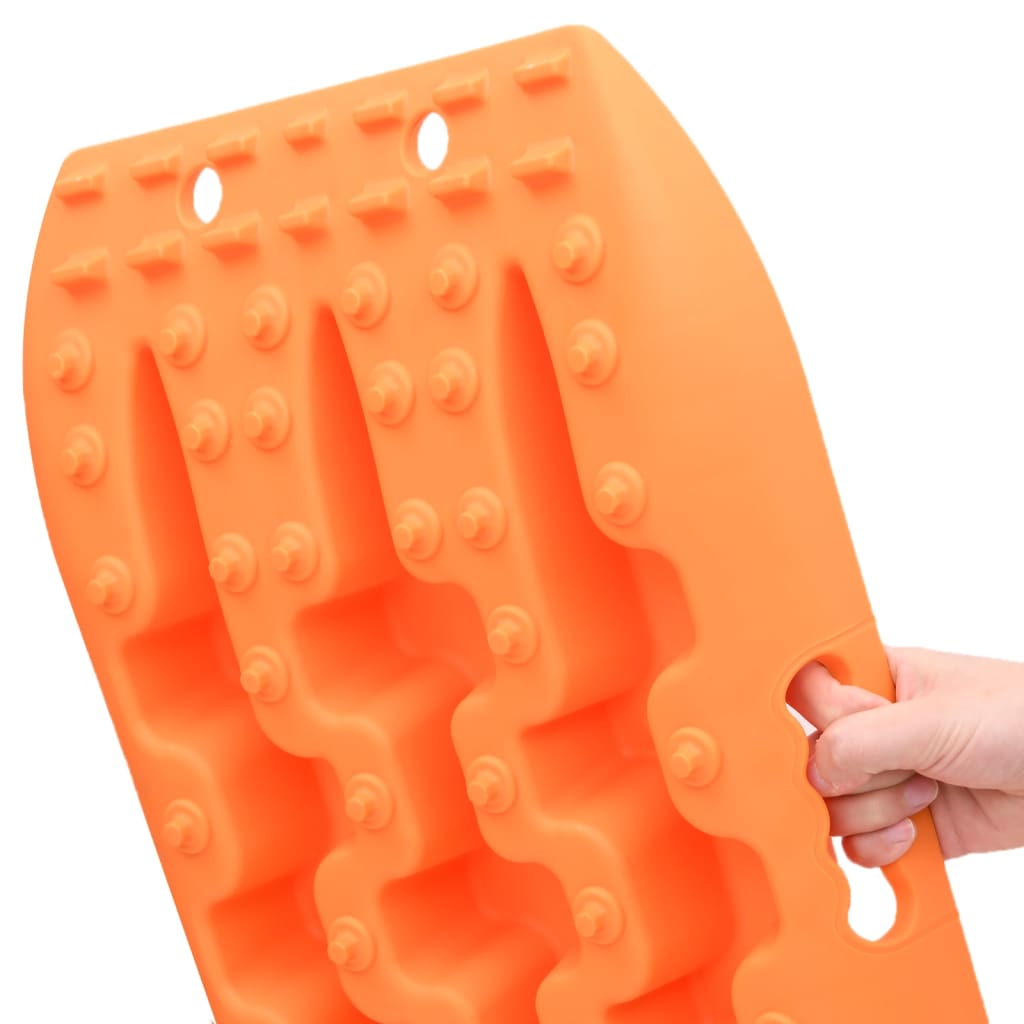 Orange reinforced nylon traction boards with teeth and handles, shown from side view.