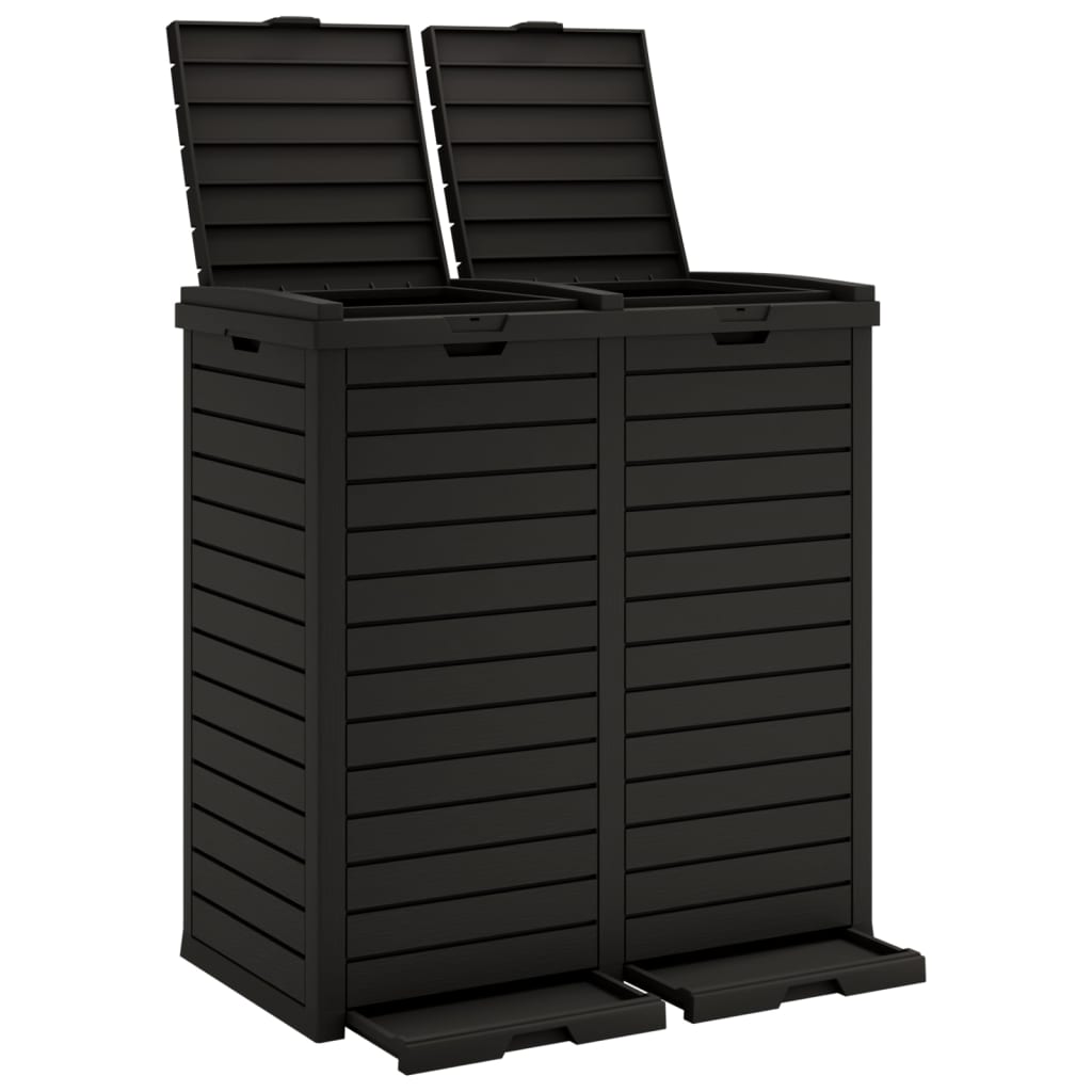 Black polypropylene outdoor garbage bin with two compartments, open lids, and foot pedals, 60.8-gallon capacity.