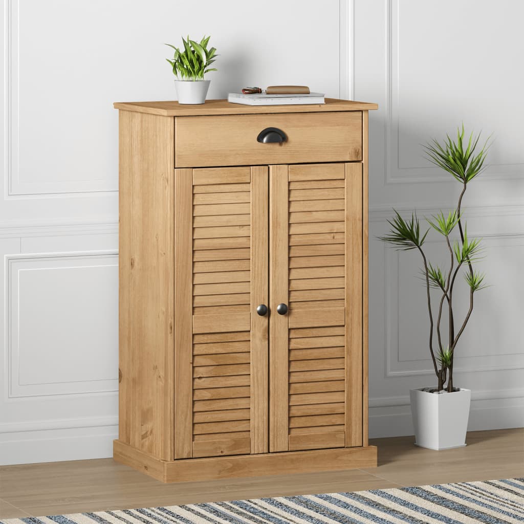 Tall wooden shoe cabinet with shutter doors, drawer, and potted plant nearby.