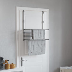 Silver aluminum over-the-door drying rack with two tiers holding folded gray towels.