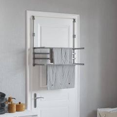 Aluminum retractable balcony drying rack with extendable bars and foldable levels hanging on a door.
