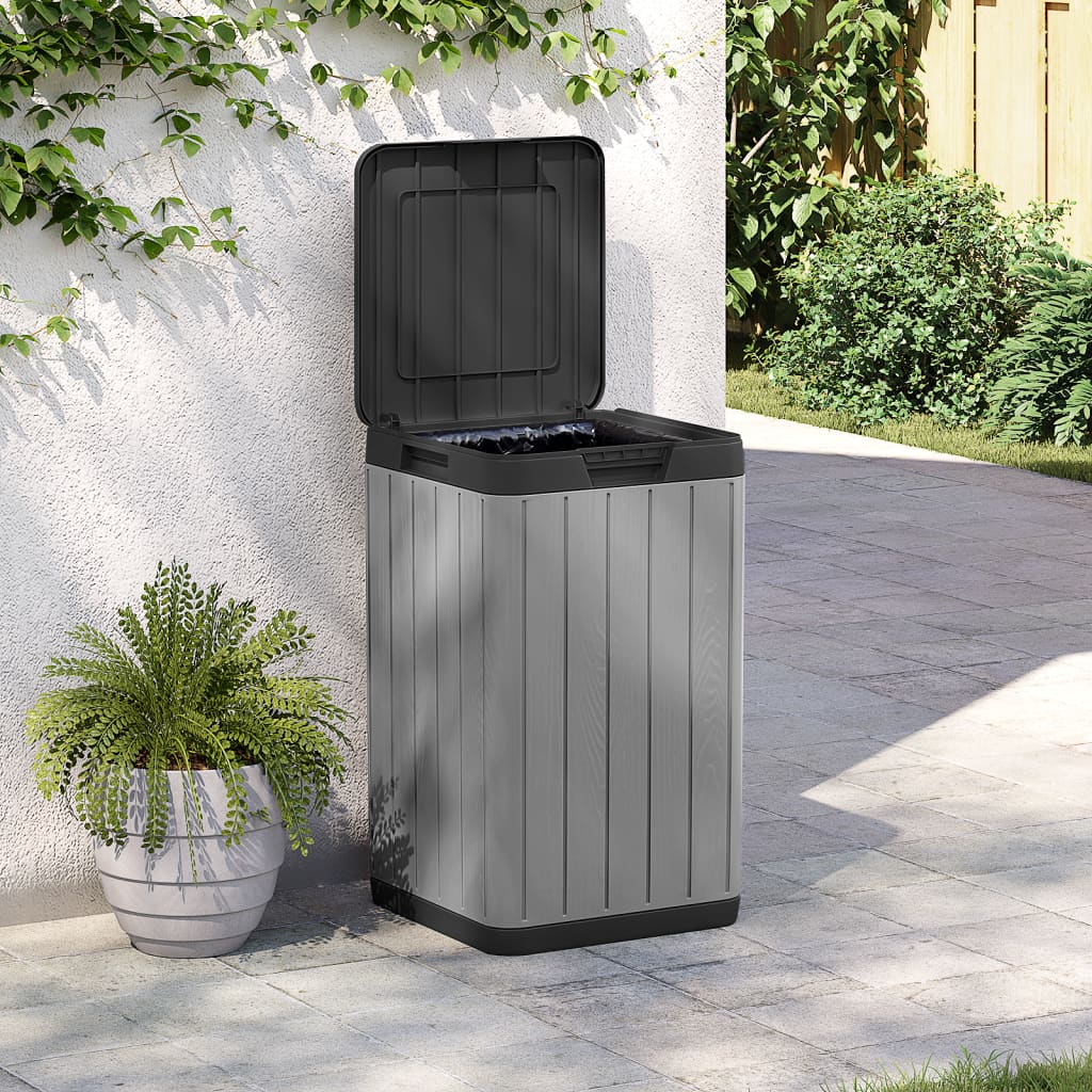 Gray Bostome outdoor garbage bin with open lid, 21.1-gallon capacity, placed on patio near plants.