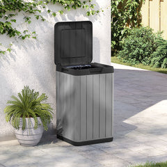Gray Bostome outdoor garbage bin with open lid, 21.1-gallon capacity, placed on patio near plants.
