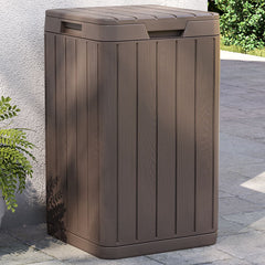 Brown Bostome 21.1-gallon outdoor garbage bin with wood-like slatted design on patio.