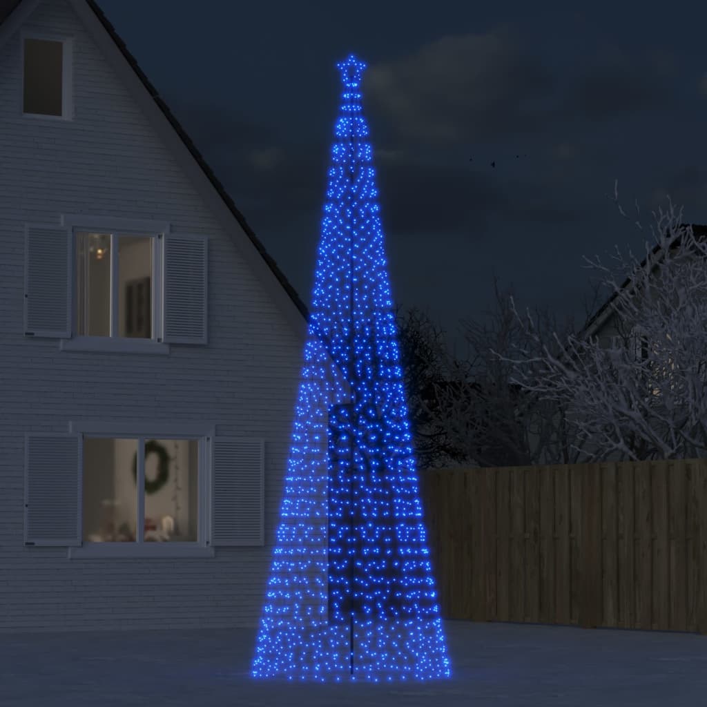 A tall blue LED Christmas tree with 1554 lights stands in a snowy yard at night.