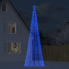 A tall blue LED Christmas tree with 1554 lights stands in a snowy yard at night.