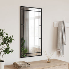 Black rectangular wall mirror with iron frame, measuring 15.7 by 31.5 inches, hung vertically.