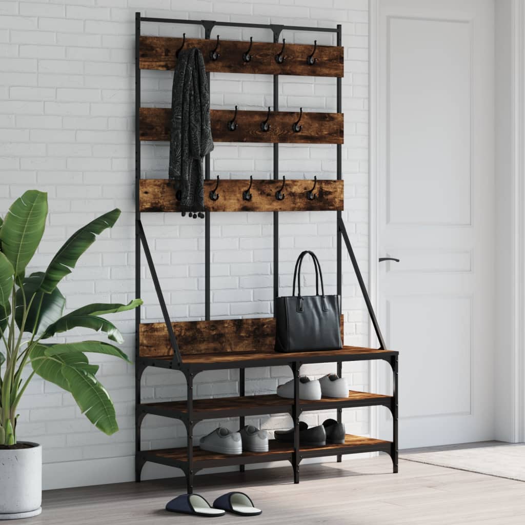 Smoked oak clothes rack with hooks, shelf, and shoe storage on black metal frame.