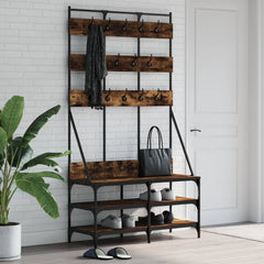 Smoked oak clothes rack with hooks, shelf, and shoe storage on black metal frame.