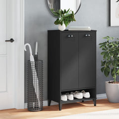 Black engineered wood shoe cabinet with two doors and an open shelf holding five pairs of shoes.