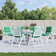 Six green Oxford fabric lowback chair cushions with ties, displayed on white patio chairs around a table in a garden.