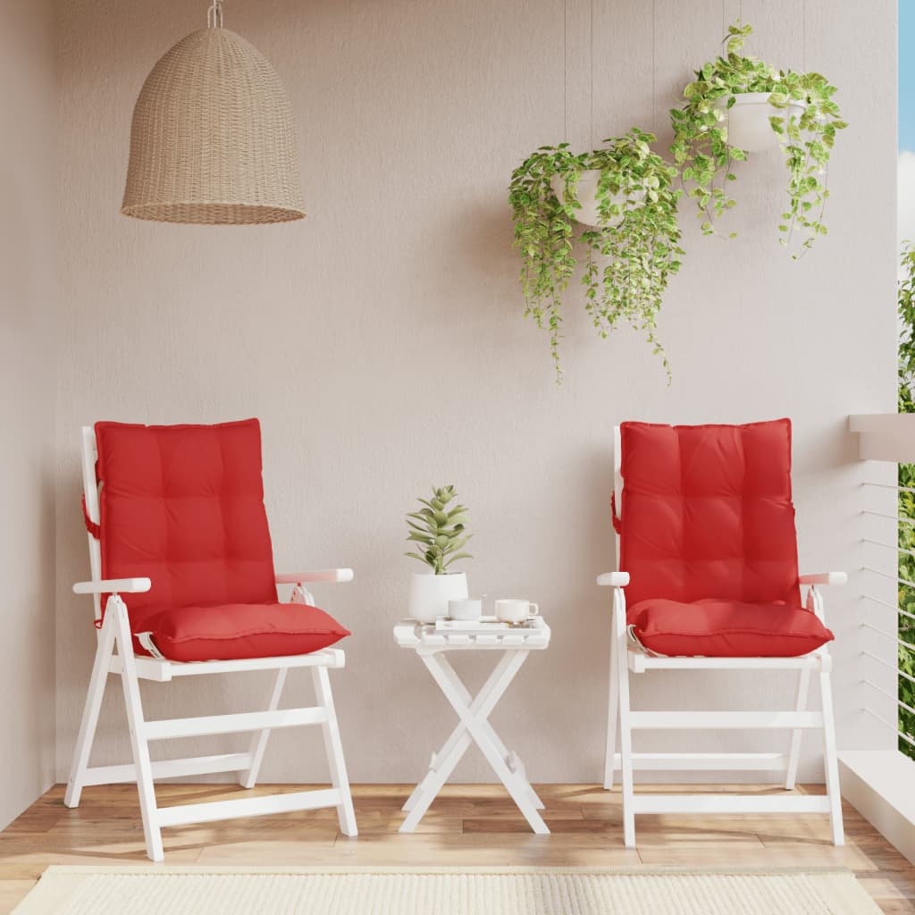 Two red Oxford fabric lowback chair cushions with tufted design and straps.