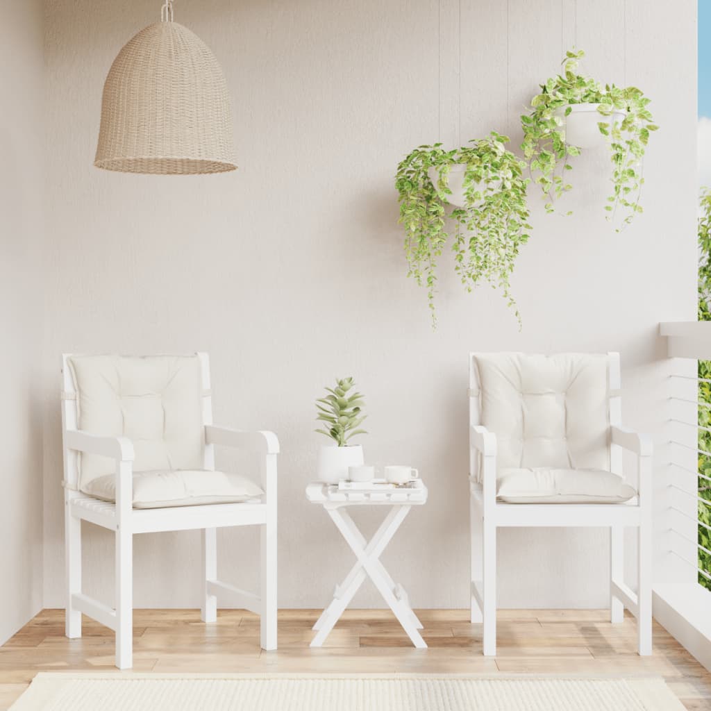 Two cream melange fabric lowback chair cushions on white patio chairs with a small table.