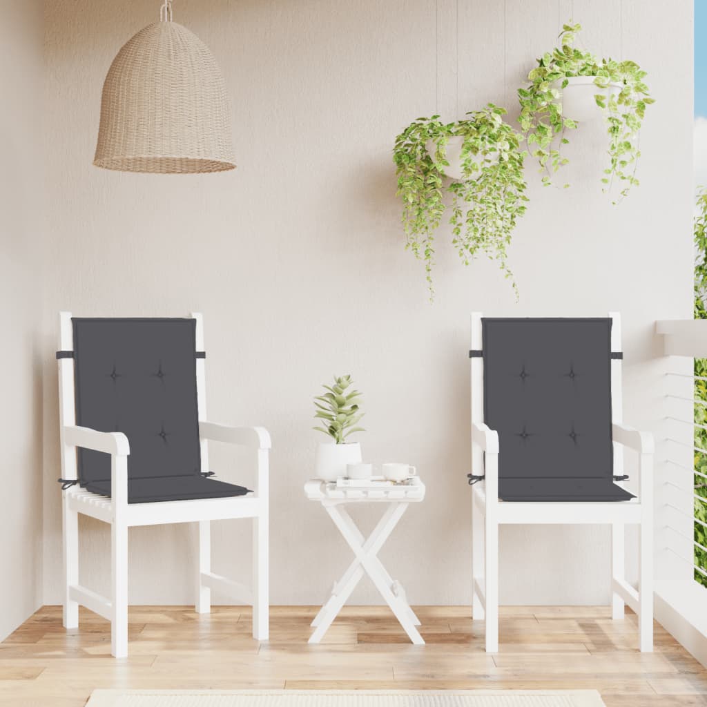 Two anthracite melange fabric lowback chair cushions on white outdoor chairs with a small table.
