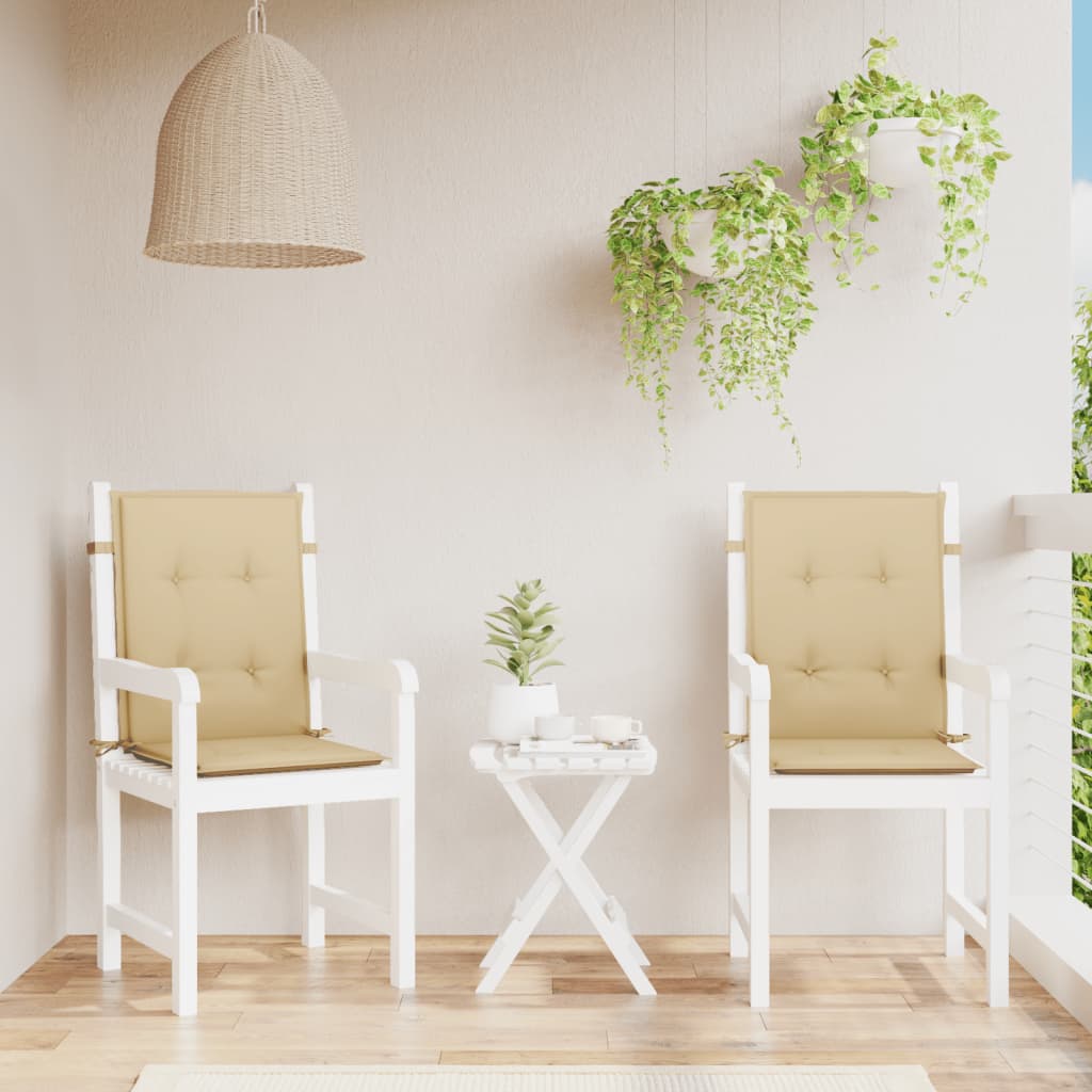 Two beige melange fabric lowback chair cushions on white chairs with a small table.
