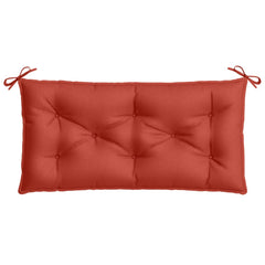 Red rectangular garden bench cushion with tufted polyester surface and tie straps.