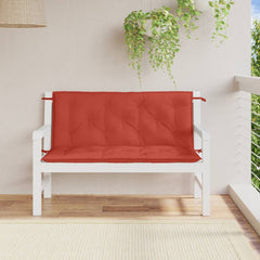 Red melange garden bench cushions with tufted design and ties on a white wooden bench.