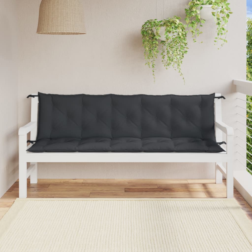 Two anthracite melange garden bench cushions on a white wooden bench on a sunny patio.