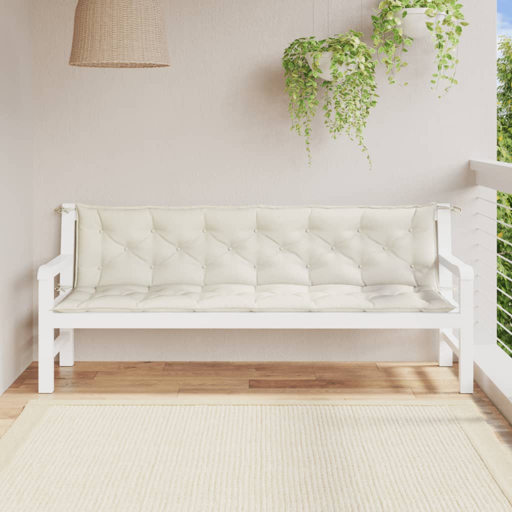 Two cream melange fabric bench cushions with tufted design on a white garden bench.