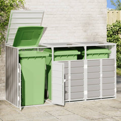 Gray steel wheelie bin storage unit holding three green bins with open lids against a brick wall.