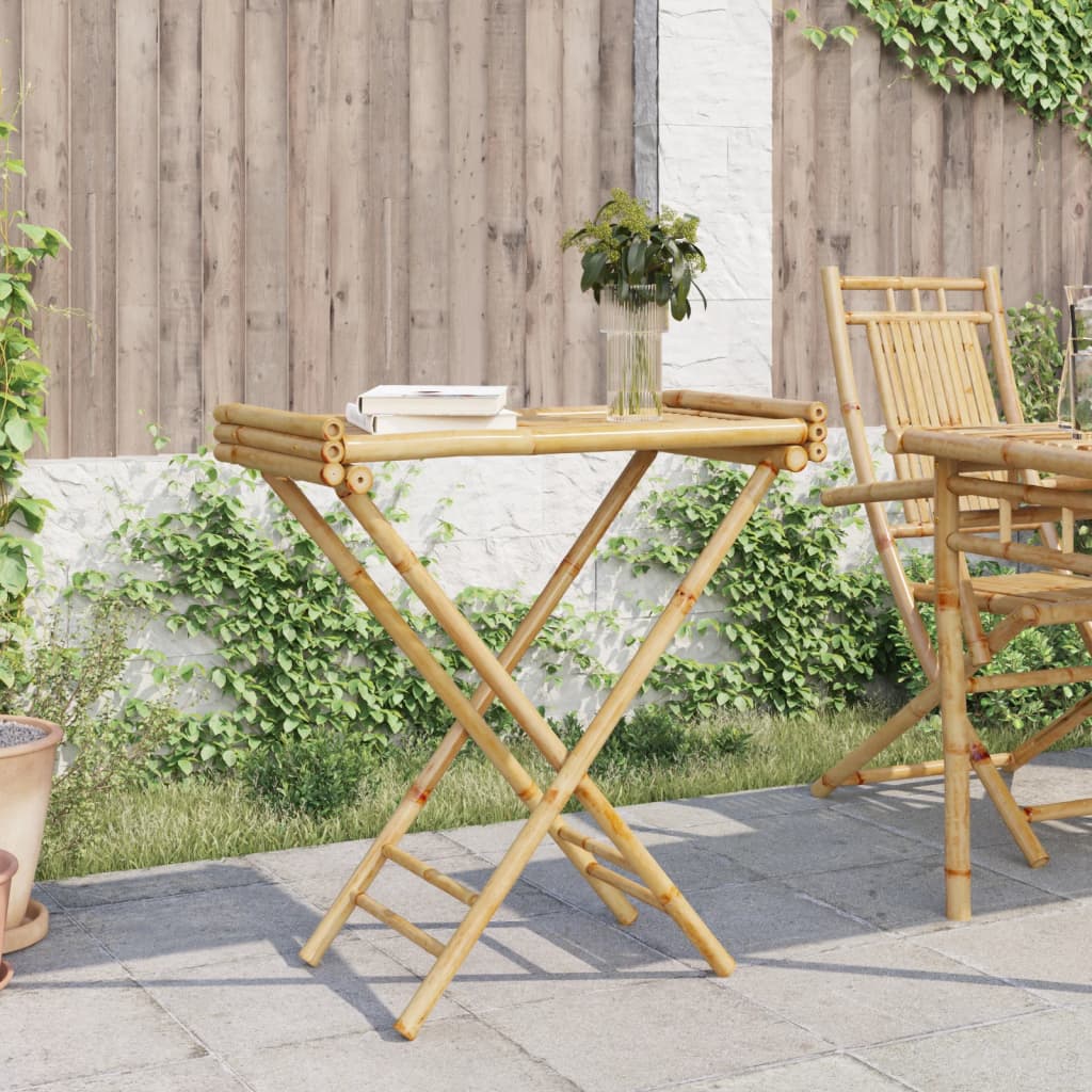 Bostome bamboo folding tray table with slatted top, open on patio with book and vase.