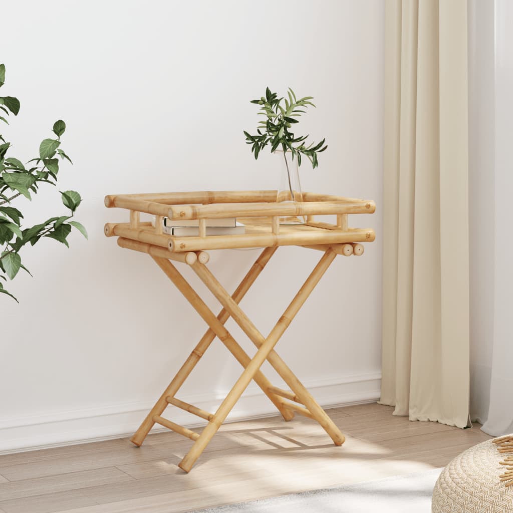 Bostome bamboo folding tray table with slatted top and X-frame legs, holding a book and plant.