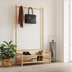 Bamboo clothes rack with upper hanging bar, lower shoe shelf, and folded clothes.