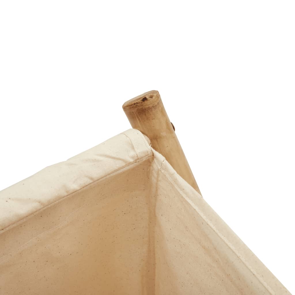 Close-up of a cream white fabric laundry basket with a bamboo frame.