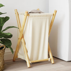 Bostome bamboo laundry basket in cream white with folded towels inside.