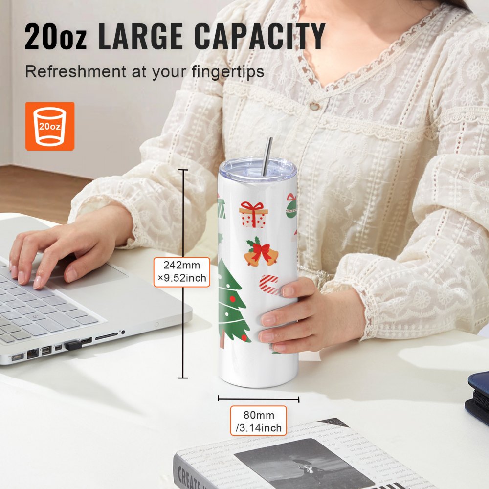 A woman holding a 20oz blank stainless steel tumbler with Christmas designs, shown with dimensions 24cm x 8cm, next to a laptop on a desk.