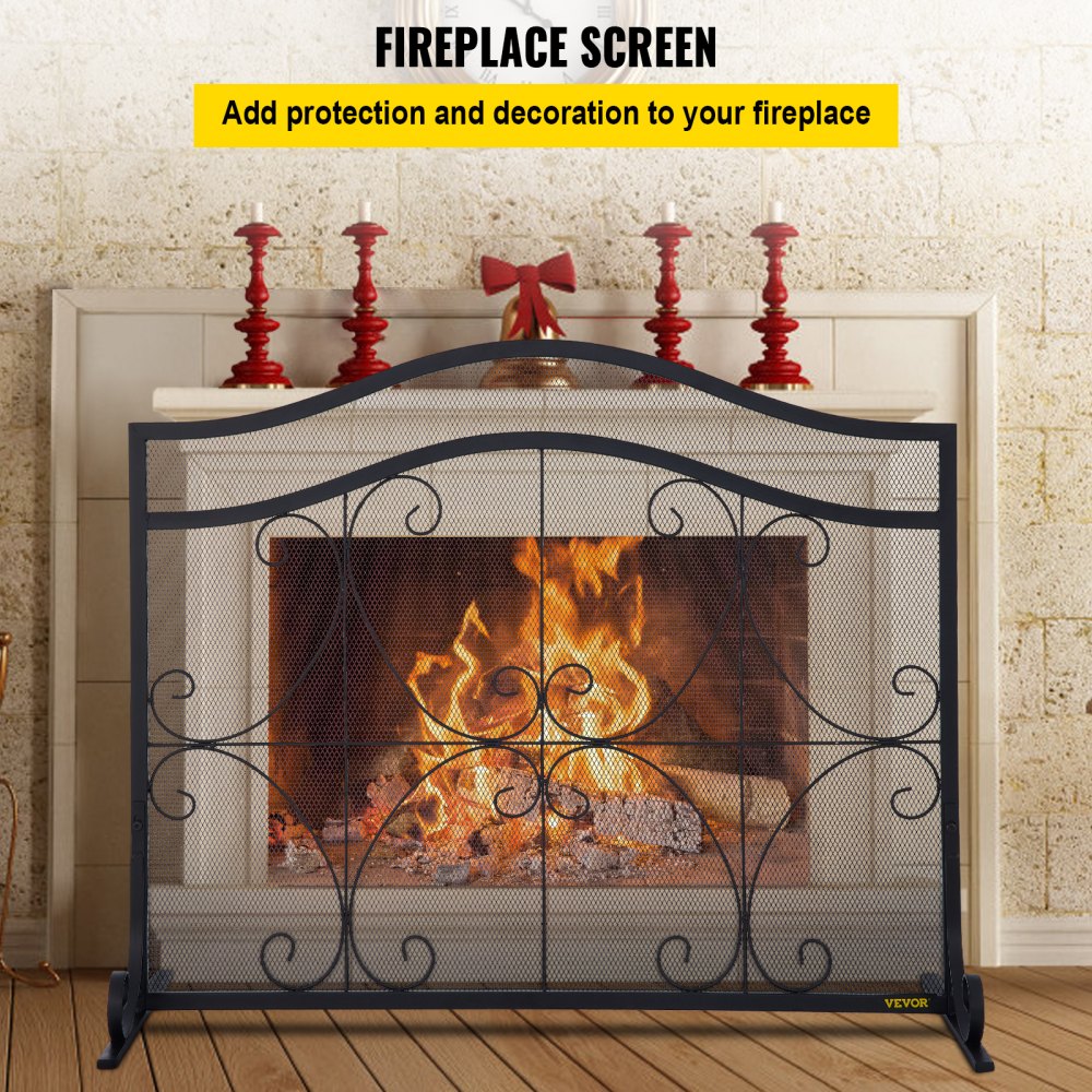 Black heavy-duty iron fireplace screen with double doors and geometric patterns.