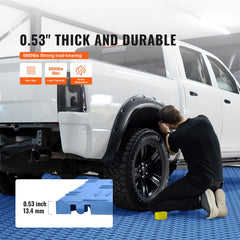 Blue interlocking garage floor tiles, 12x12x0.53 inches, shown installed under a white truck with a man kneeling nearby.
