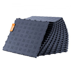 Stack of graphite gray interlocking garage floor tiles with diamond texture and orange tag