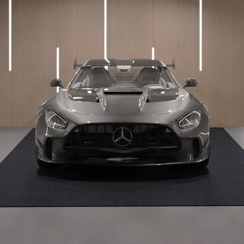Gray-black Bostome waterproof non-slip garage floor mat, 6.6x8.5 ft, on concrete with silver car.