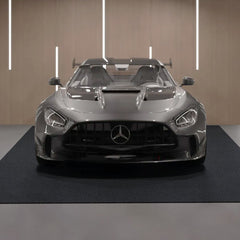 Gray-black Bostome waterproof non-slip garage floor mat, 6.6x8.5 ft, on concrete with silver car.