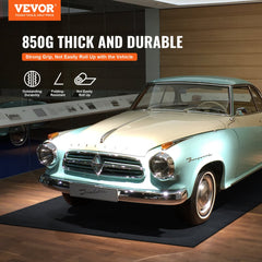 Gray-black Bostome garage floor mat rolled out under a turquoise classic car, featuring thick felt top and waterproof TPE backing.
