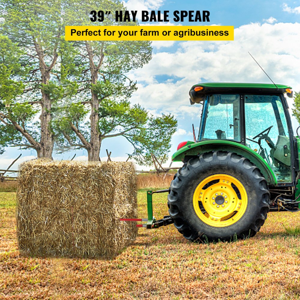 A green tractor with a red-coated 39-inch hay bale spear attached lifts a large hay bale in a field.