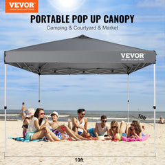 A 10x10 ft dark gray waterproof pop-up canopy tent set up on a beach with people relaxing underneath.