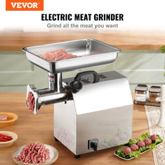 Silver Bostome 1100W electric meat grinder with stainless steel tray and ground meat on kitchen counter.