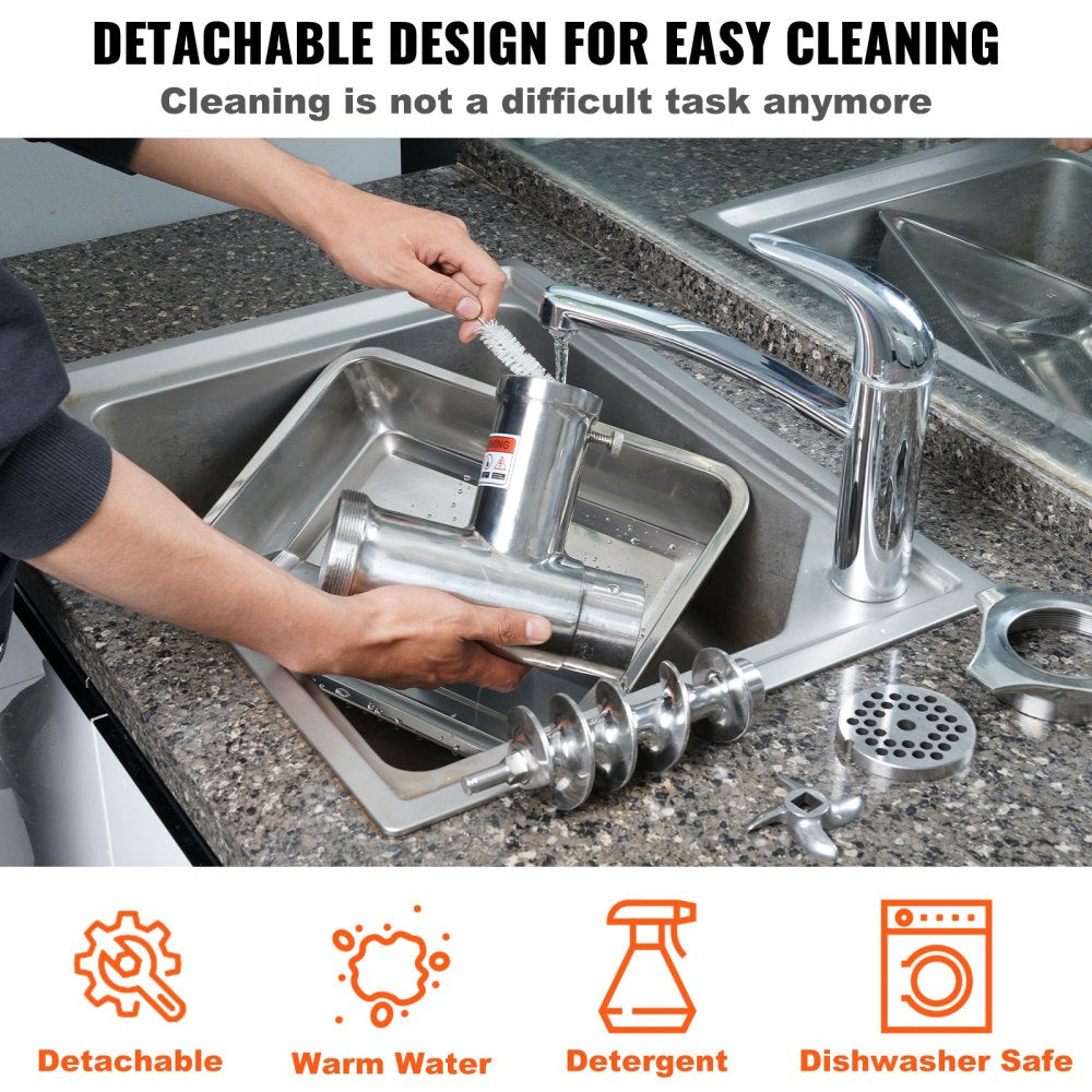 Hands disassembling a stainless steel electric meat grinder in a sink for cleaning.