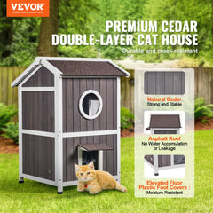 Two-story cedar wood outdoor cat house with a triangular roof and large double doors.