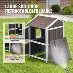 Two-story cedar wood cat house with a triangular roof and large double-sided doors.