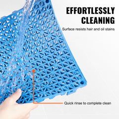Blue PVC interlocking drainage tile with water rinsing off, showing easy cleaning of hair and oil stains.