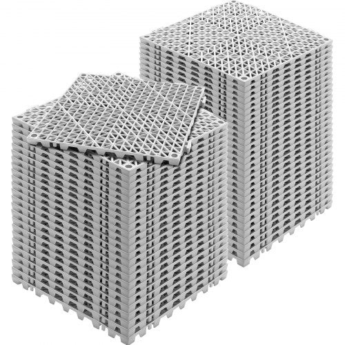 Stack of 55 grey PVC interlocking drainage tiles, each 12x12 inches with perforated surface.